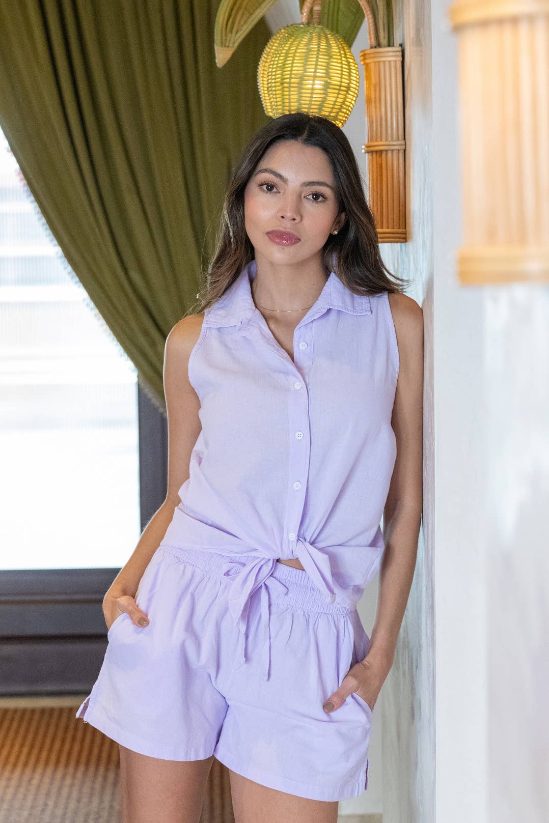 woman wearing a purple two piece set with a tie top in an all womens clothing collection for cita coastal resort wear boutique