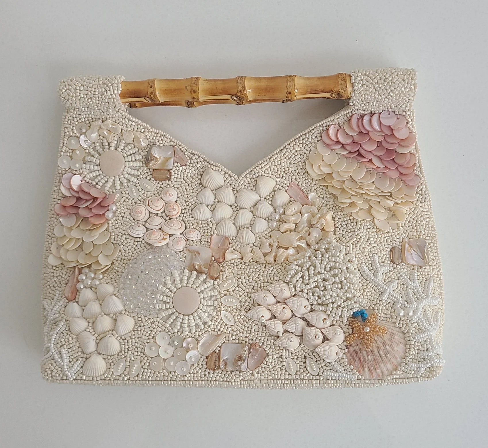 Cream Seashell Beaded Clutch Bag with bamboo handle. Found in a beaded bag collection from Cita Coastal Resort Wear.