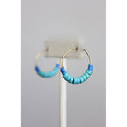 Gold hoop earrings with blue and green beaded accents 