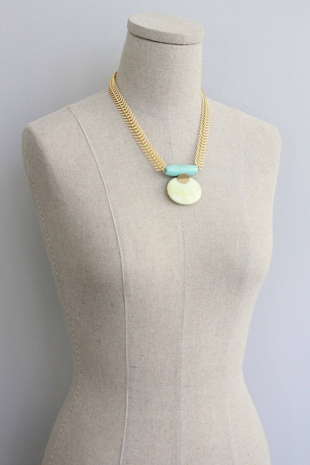 Large pendant Turquoise and Lemon Herringbone Necklace on a mannequin
