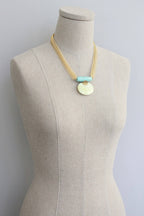 Large pendant Turquoise and Lemon Herringbone Necklace on a mannequin