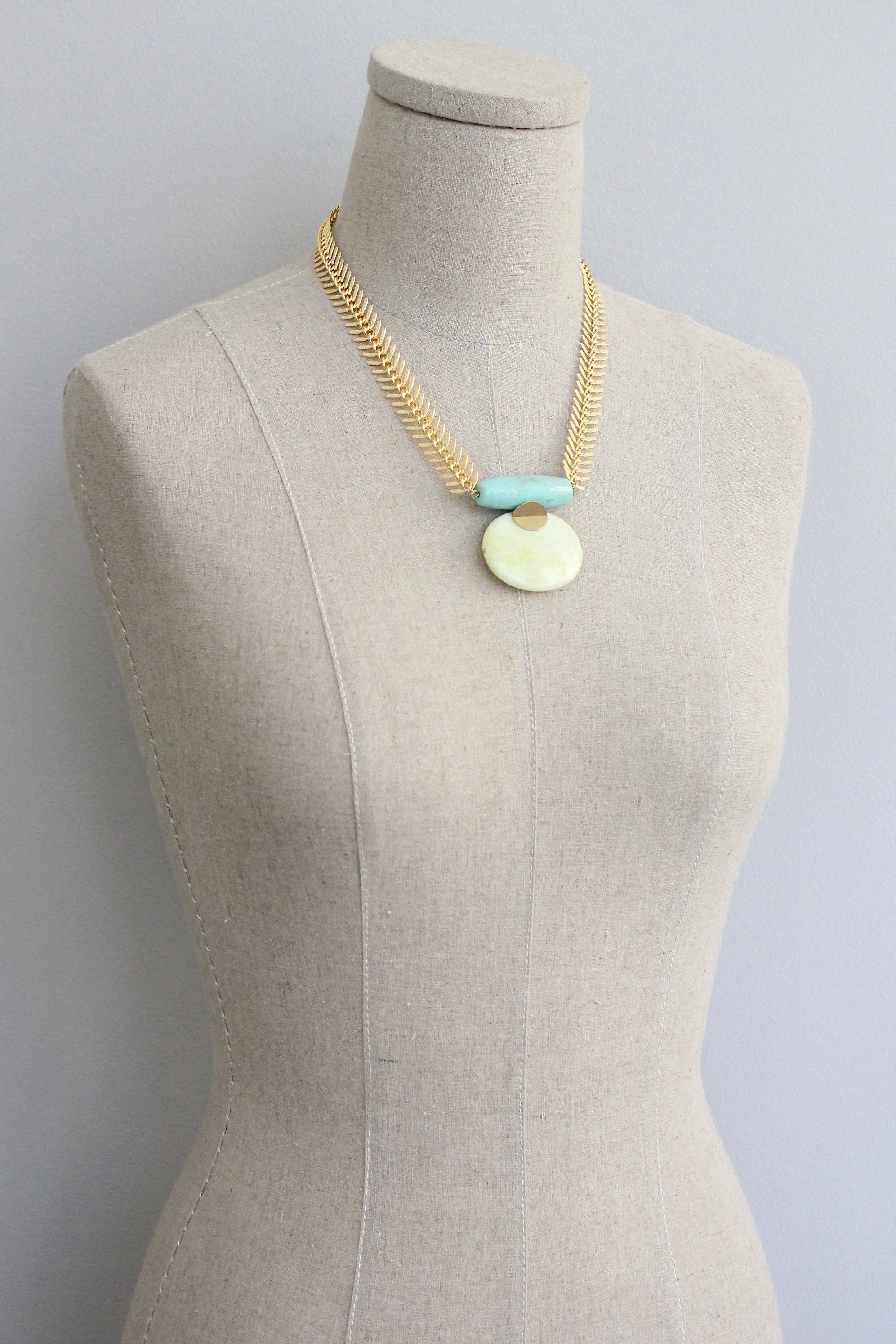 Large pendant Turquoise and Lemon Herringbone Necklace on a mannequin